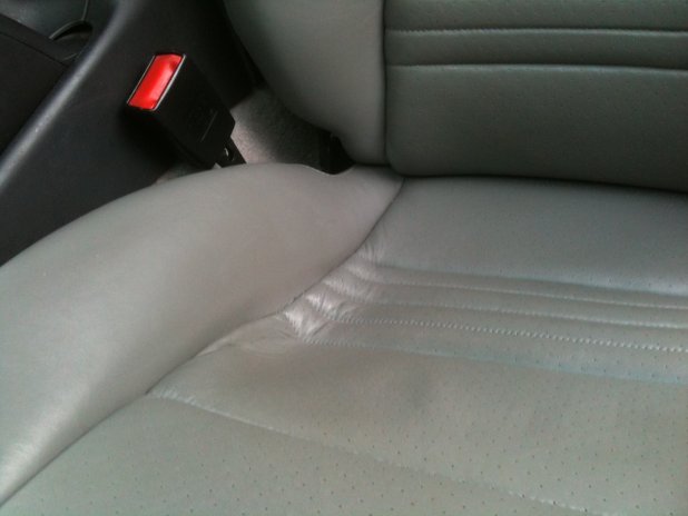 Worn car seat showing sunken seat pan