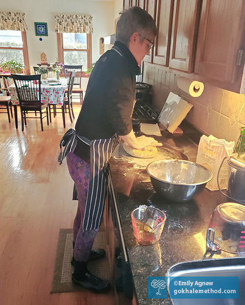 Emily Agnew kneading bread, keeping her shoulders back.