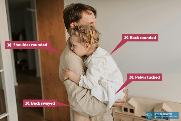 Man carrying his young daughter, slumped to his chest