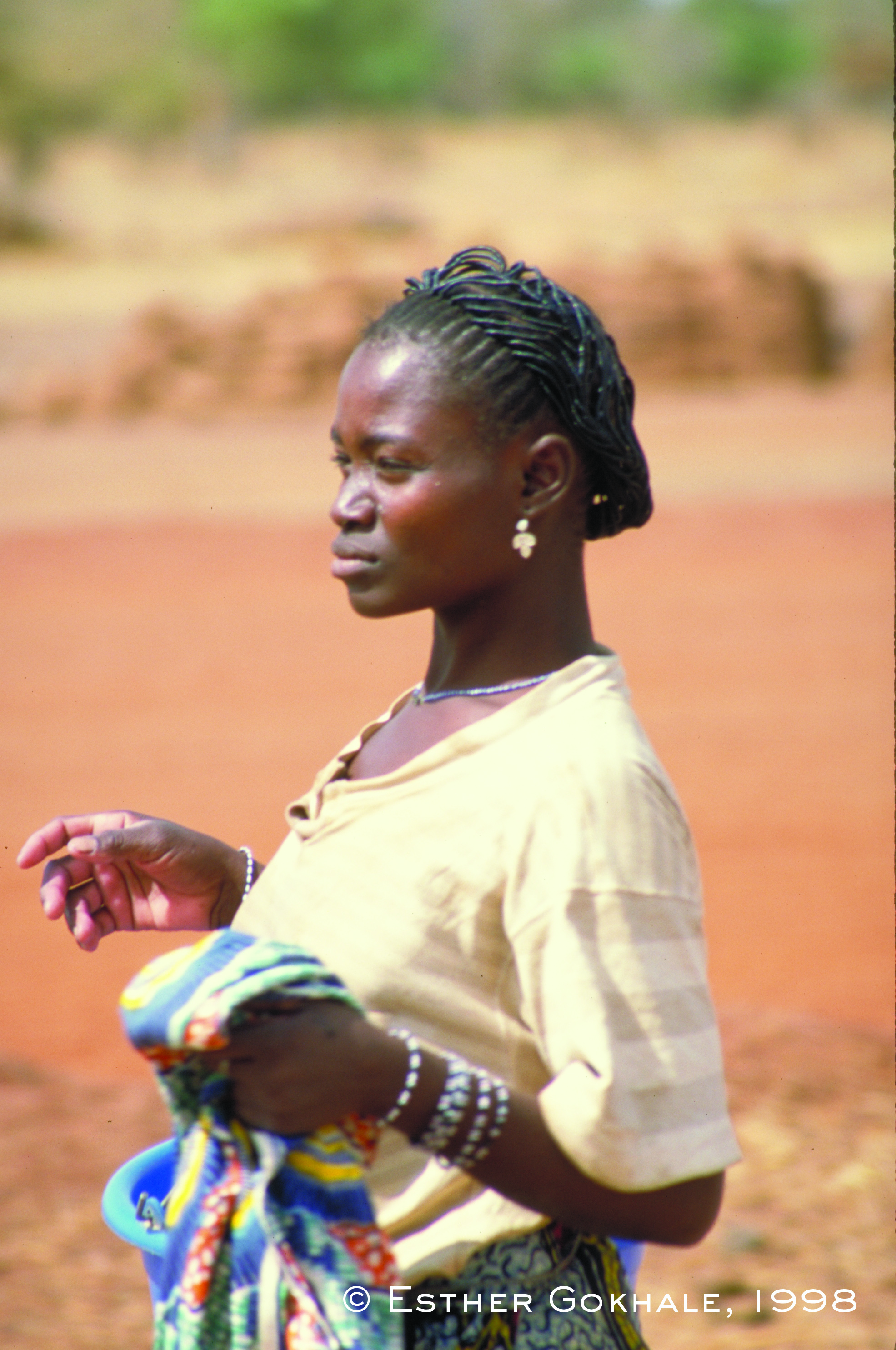 Burkina Faso woman hangs clothes out to dry at a communal well