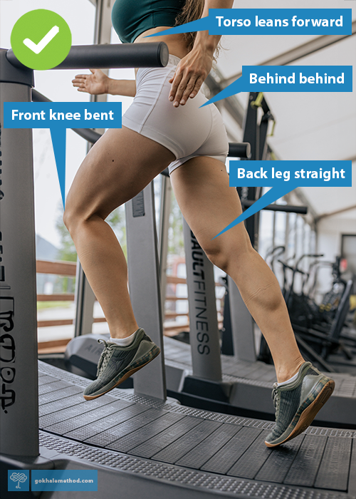 Woman running on curved HIT treadmill, lower body view.