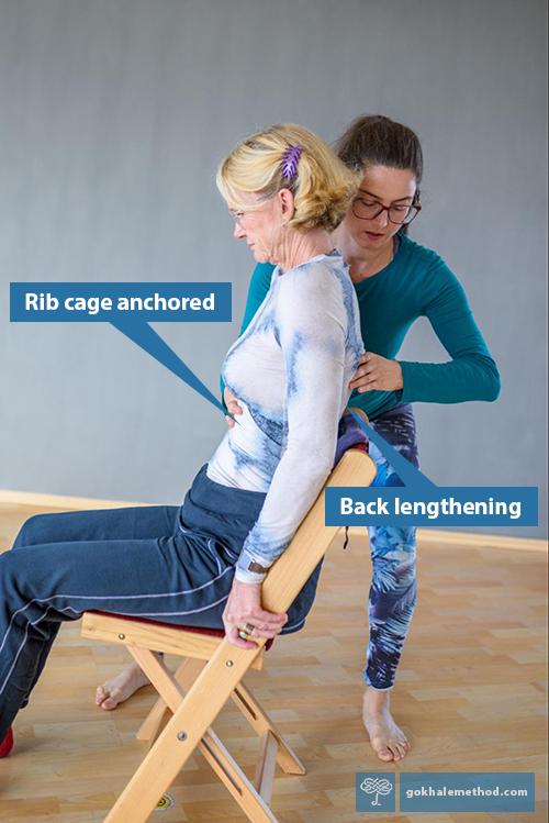 Gokhale Method teacher Sabina Baumauer guides a student in stretchsitting.