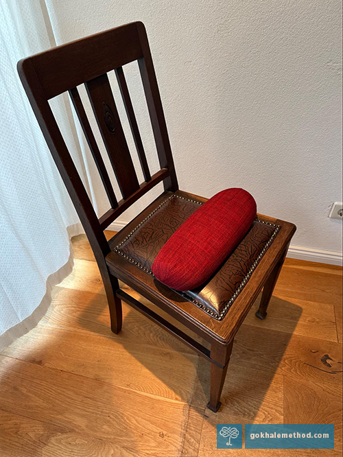 The Gokhale Wedge 2.0, positioned rounded side up on a chair.