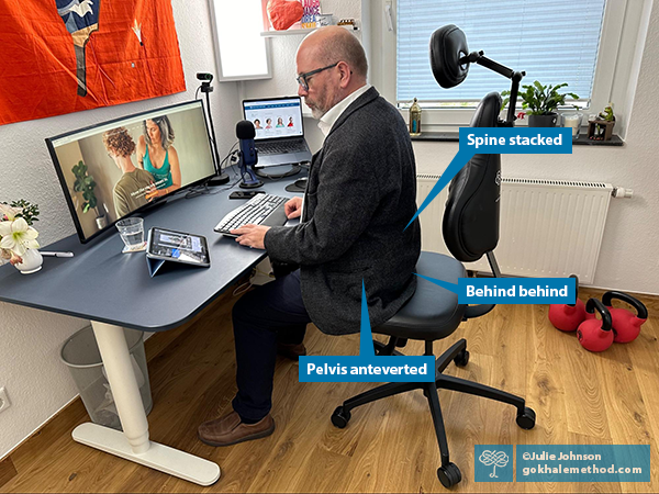 Photo of a man stacksitting at a desk in a Gokhale Executive chair.