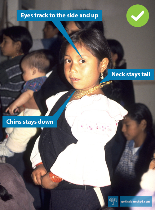 Young schoolgirl in Otavalo, Ecuador, moving her neck a little—and her eyes a lot. 