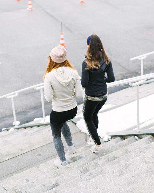 Two women descending steps.