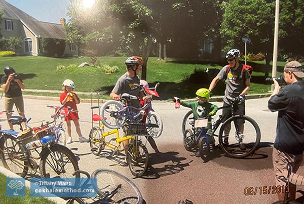 Adults and children gather with bikes for a 10k Pan Mass Challenge fundraiser.