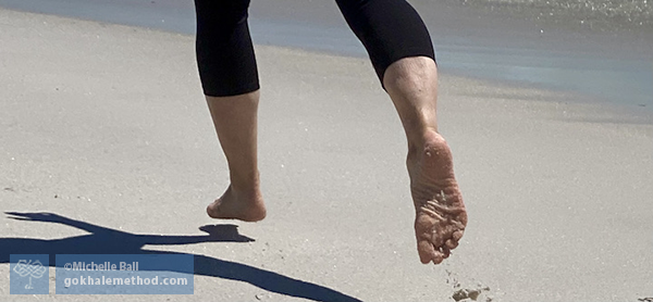 Michelle Ball, Gokhale Method teacher, running on sandy beach, close-up