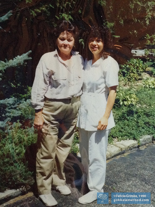 Felicia Grimke standing beside Aunt, legs internally rotated, angled view.
