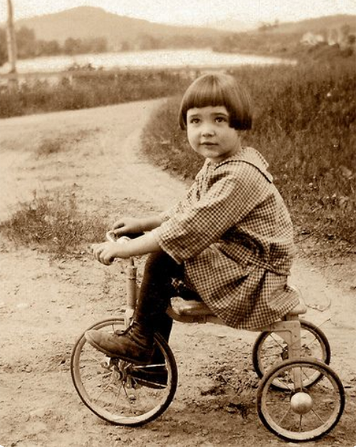 Rachel Holt on small tricycle, Dummer, New Hampshire, c. 1927. Jim Griffin, Flickr