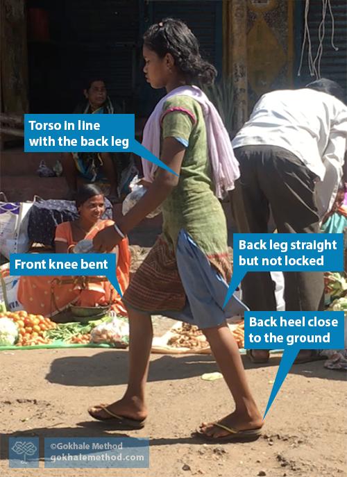 Woman walking in market, Odisha, India.