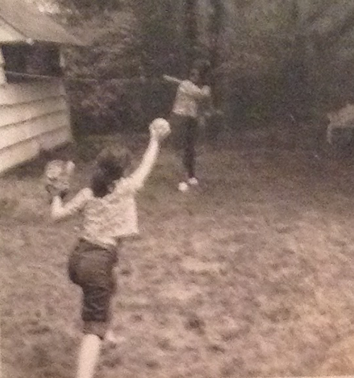 Felicia Grimke playing baseball with nanny, back view.