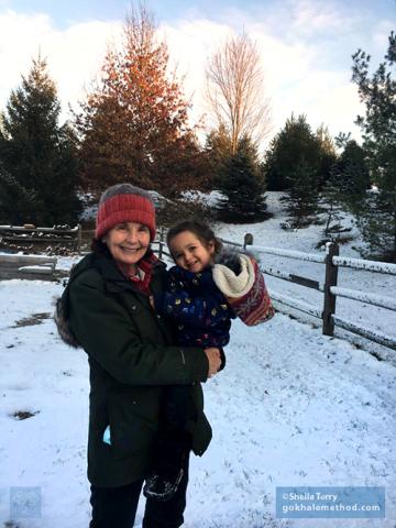 Sheila enjoying carrying her granddaughter